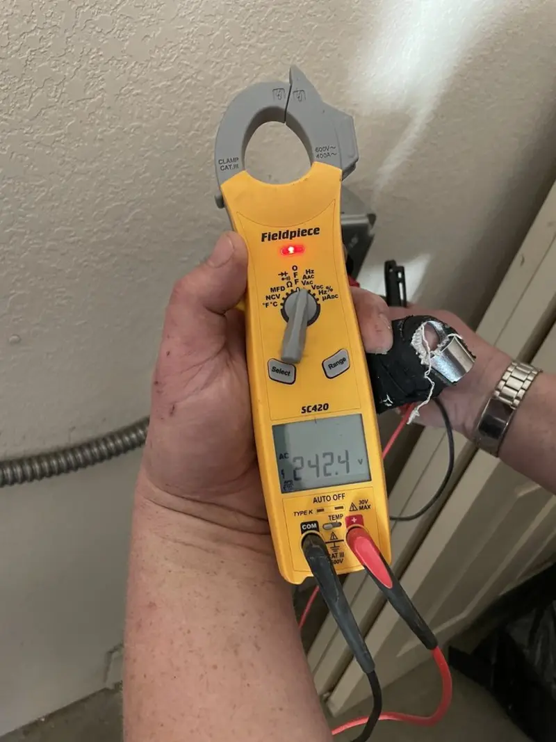 Voltage testing with clamp meter during Ceiling Fan Installation in Placentia